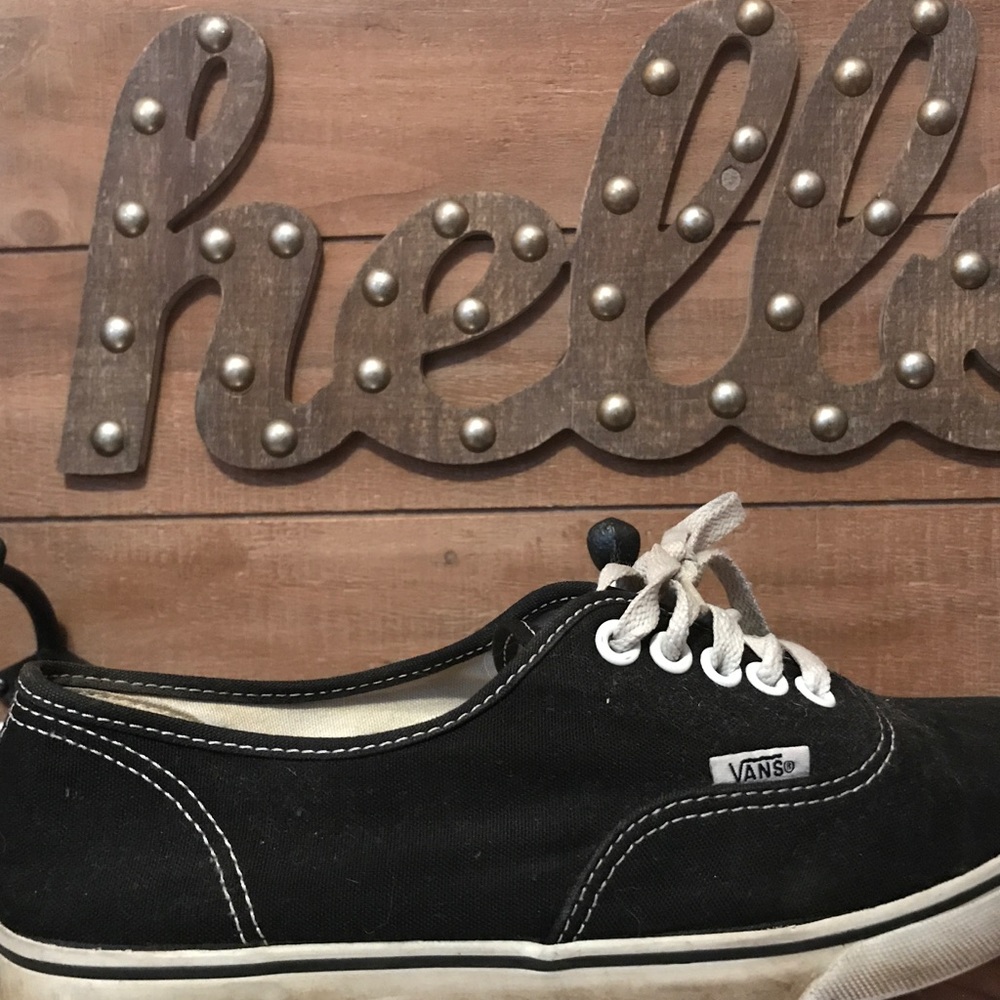 Black and white low top Vans